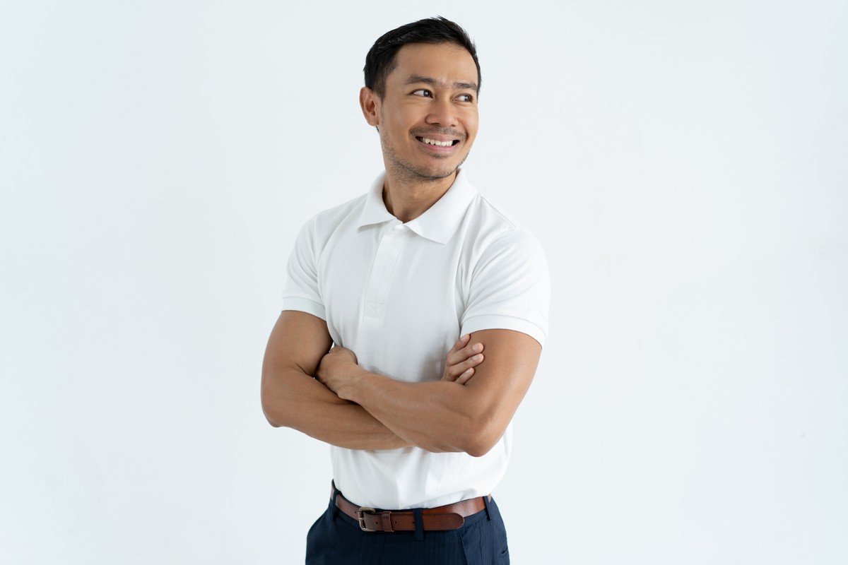 happy confident asian male entrepreneur crossing arms on chest